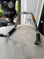 Overall view of tubular steel hook with rubber-covered arms and mounting holes