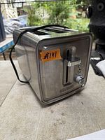 Front and side view of Black+Decker stainless steel toaster showing controls and lever