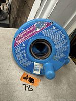 Front of blue canister auger showing label and cable inlet