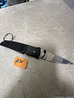 Knife fully open showing handle, blade, key ring, length reference note