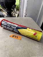 Cylindrical package labeled Tanglefoot Giant Fly Trap 30ft