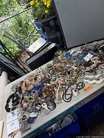 Overall view of large mixed jewellery pile on table outdoors