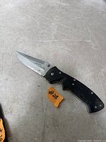 Full view of folding knife open showing blade and handle