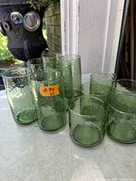 All 11 green textured glass tumblers grouped on surface