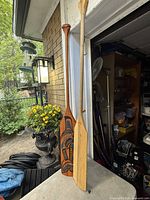 Both paddles standing side by side showing full length and design contrast