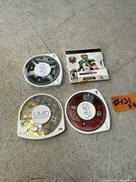 All four PSP UMD game discs laid out