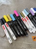 Black Artist’s Loft markers and white Craft Smart pens with assorted coloured caps