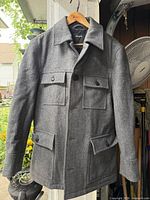 Front view of grey bruno banani jacket on hanger showing overall style and pockets