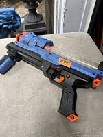 Right side view of blue and orange Nerf Rival blaster showing clear magazine and overall condition