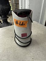 Front view of Tech1 cylindrical speaker with cable wrapped around