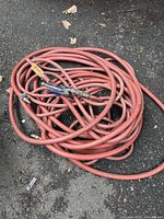 Coiled red air hose with quick-connect fittings visible
