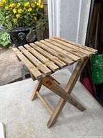 Slatted solid wood folding stool standing open
