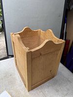 Front/side view showing scalloped rim and wood grain