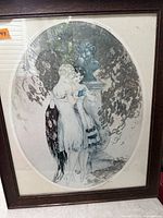 Full view of framed oval-matted print