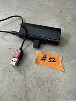 Top view of black Anker Lightning power bank with attached charging cable and USB-A plug