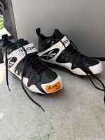 Pair of Reebok RBK NFL football cleats side view