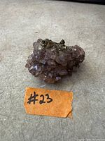 Overall view of the amethyst cluster showing crystal terminations and pyrite inclusions with scale reference