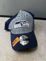 Front view of navy and grey Seattle Seahawks 39THIRTY cap with logo and size sticker