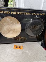 Front view of sealed Wood Protection Package showing contents