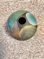 Top view showing narrow neck opening and multicolor raku glaze