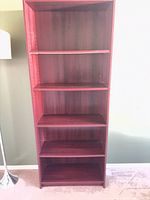 Full front view of tall mahogany laminate bookcase showing six shelves