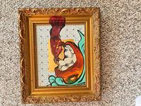 Front view of framed painting showing artwork and ornate gold frame