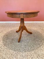 Full view of table showing round top and pedestal base