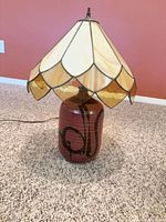 Full view of lamp showing stained glass shade and ceramic base