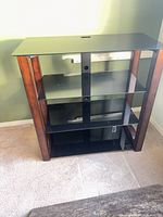 front view showing three glass shelves and wood frame