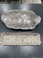 Both trays top view showing size difference and motif