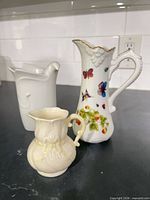 All three pitchers and creamers grouped