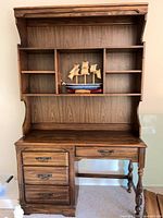 Front view of Harrison desk with attached hutch showing drawers, kneehole drawer, turned leg, open shelves