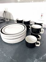 Stacked plates and mugs showing quantity and styling