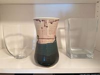 Group shot of three vases on shelf