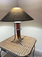 Lamp side view showing metal frame, wood center, shade
