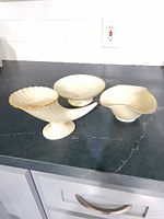 All three Lenox ivory porcelain compotes on counter