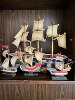 Front view of all three named model ships displayed together