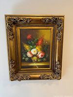 Framed floral still life hanging on wall