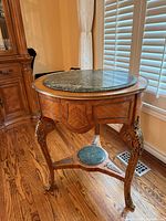 Overall view of table showing marble top, veneer, brass mounts