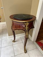 Three-quarter view showing full table, marble inset, ormolu mounts and cabriole legs
