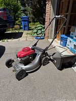 Left side view of Honda lawn mower with bag attached