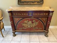 Front angled view showing marble top, gilt mounts, claw feet, fluted columns