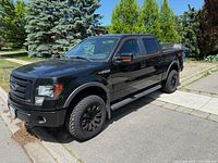 Front left angle showing exterior condition, aftermarket wheels, tire tread, body panels