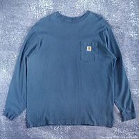 Front view of the black Carhartt long sleeve shirt showing overall design and pocket logo
