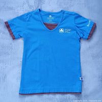Front view of blue Girl Guides Brownies T-shirt showing overall condition and design