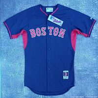 Front view of jersey showing color, lettering, button design, hem patch