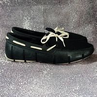 Side view of both loafers showing overall style, color and condition