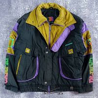 Front view of colour-block Campri ski jacket showing pockets, collar and sleeve graphics