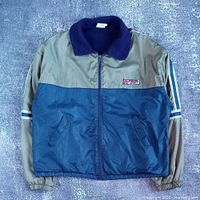 Front view of blue and tan colour-block Pinzel Sport zip-up jacket