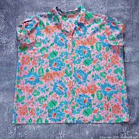 Front view of floral pattern shirt laid flat